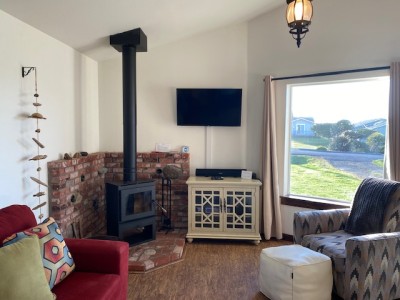 Living room with Woodstove, Smart TV includes Satelite and DVD.