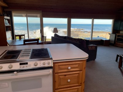 View of the dining area, living room, and ocean from the kitchen.