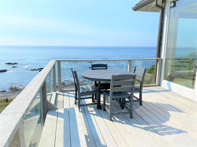 Dining table and chairs on oceanview deck.