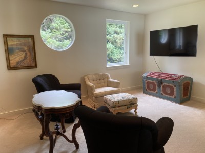 Comfortable seating in the upstairs bedroom/media room with 55" flatscreen TV.